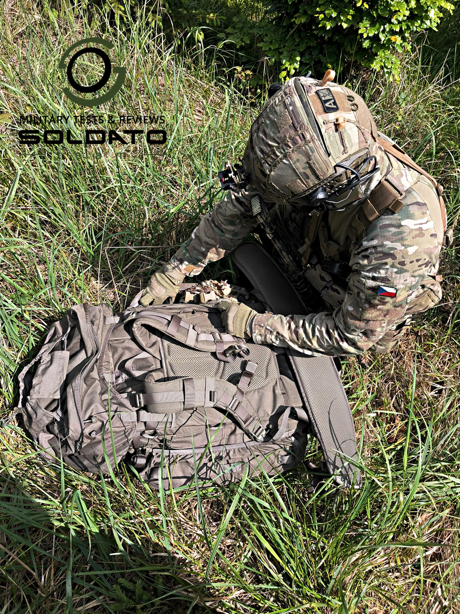 Vyjmutí vybavení z bočních kapes, když je batoh Snigel 100l položený. 