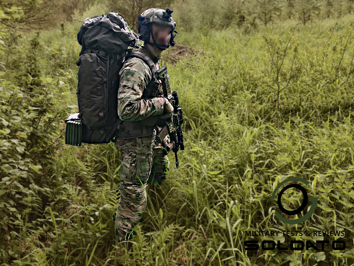 Boční pohled na vojáka v multicam s batohem Snigel na zádech. 